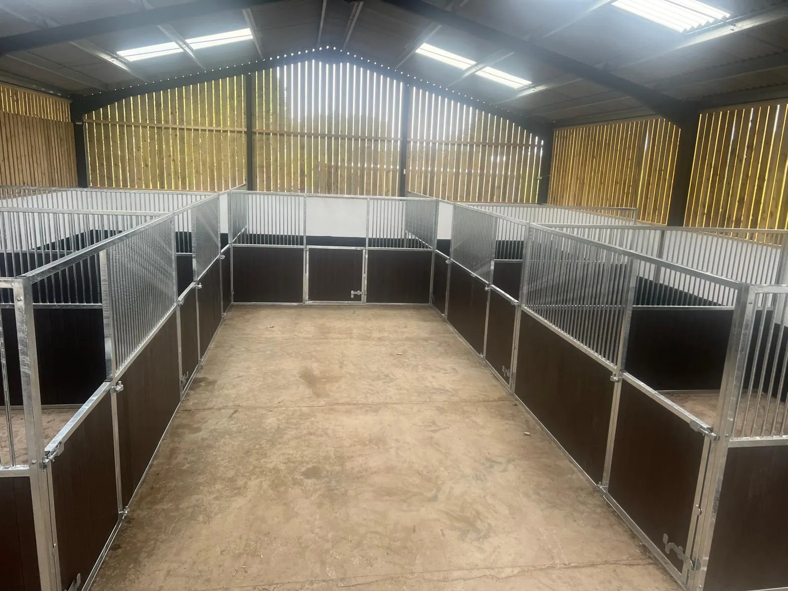 Several internal stables facing a bright central aisle