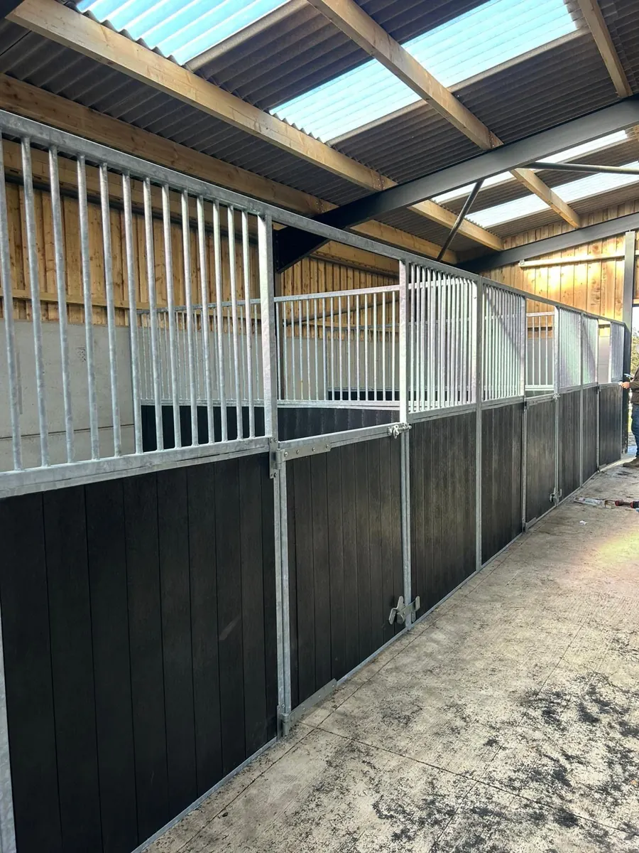 Stable front with dark lower panels and light metal bars above